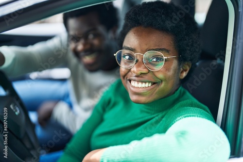 African american man and woman couple driving car at street © Krakenimages.com