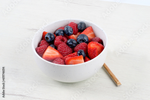 Принти на полотні White bowl with red fruits on white background