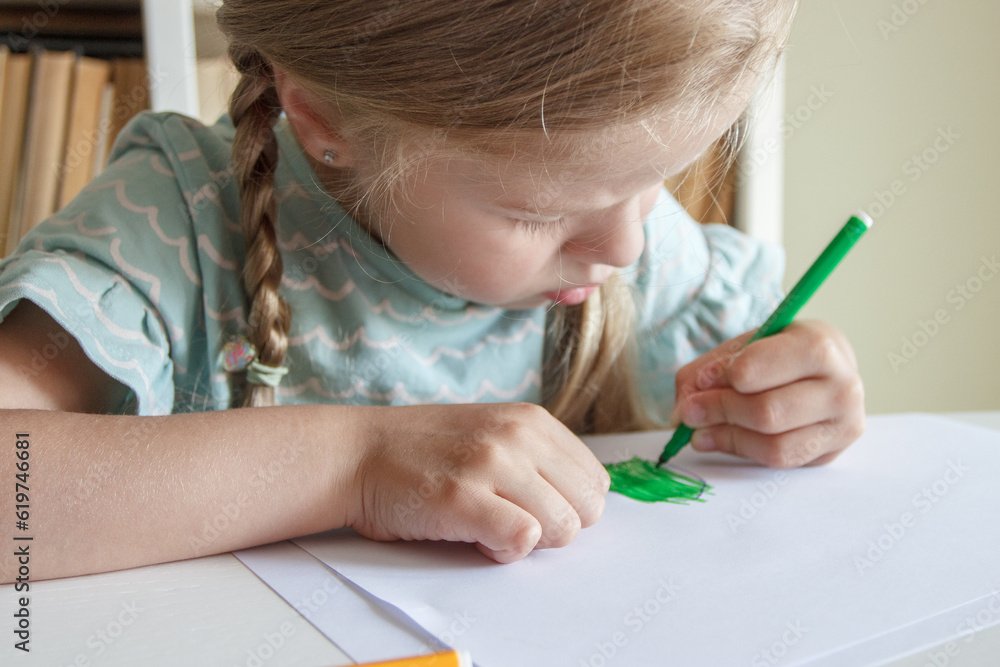 Cute child drawing a picture with colored felt-tip pens. Concept of education Cute child drawing a picture with colored felt-tip pens. Concept of education