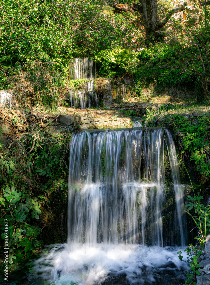 A small cascading waterfall in a small stream.