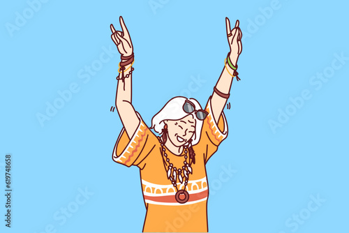Mature hippie woman in fashionable clothes and accessories enjoys life dancing at parties. Elderly woman with gray hair having fun after retirement visiting carnivals or festivals for hippie 