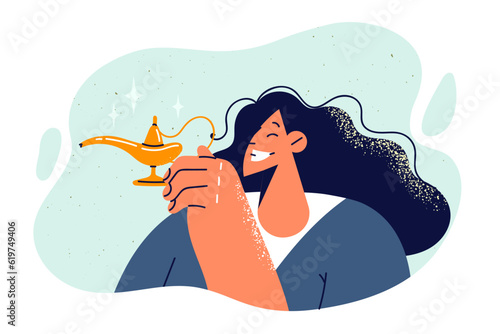 Woman holds aladdin lamp and wants to make wish or summon magical genie from fairy tales