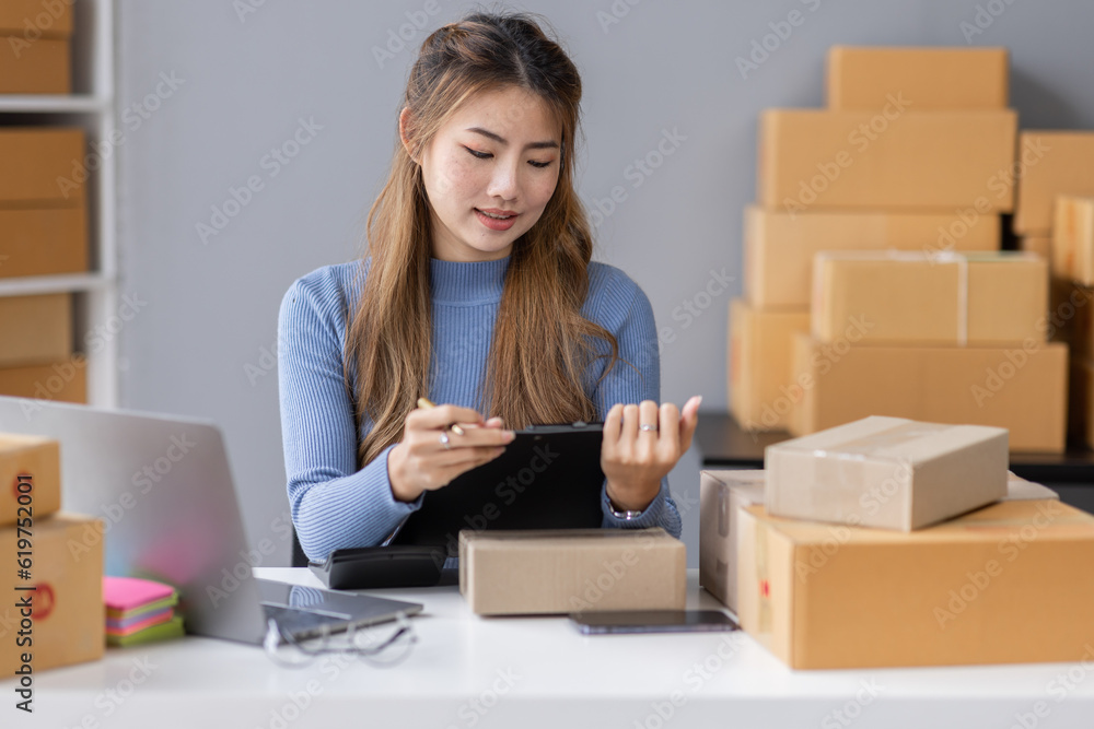 Portrait of asian young freelancer small business startup, SME owner, asian female entrepreneur work and check orders online at home. online SME business idea. Portrait of asian young freelancer small business startup, SME owner, asian female entrepreneur work and check orders online at home. online SME business idea.