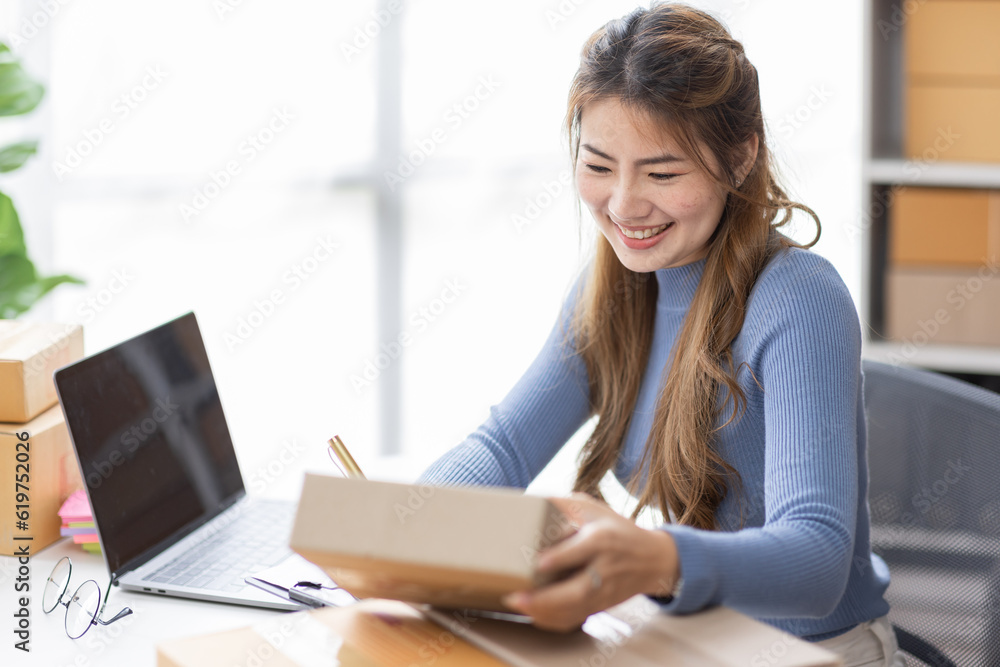Portrait of asian young freelancer small business startup, SME owner, asian female entrepreneur work and check orders online at home. online SME business idea. Portrait of asian young freelancer small business startup, SME owner, asian female entrepreneur work and check orders online at home. online SME business idea.