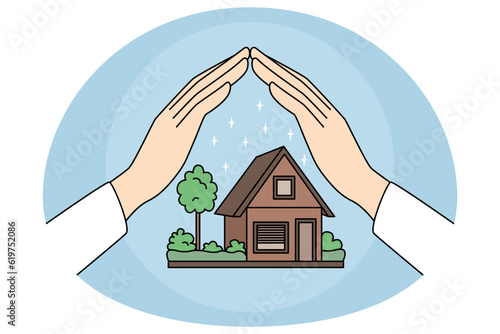 Hands protecting house model