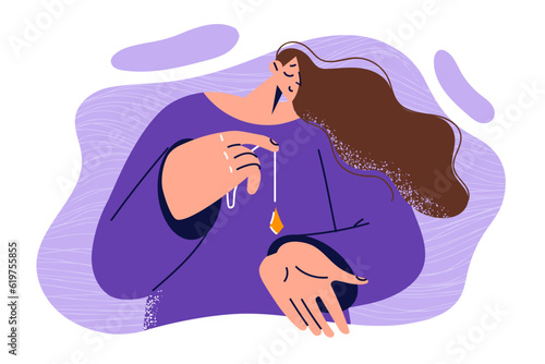 Woman holds pendulum for esoteric practices and meditates using crystal for spiritual communication