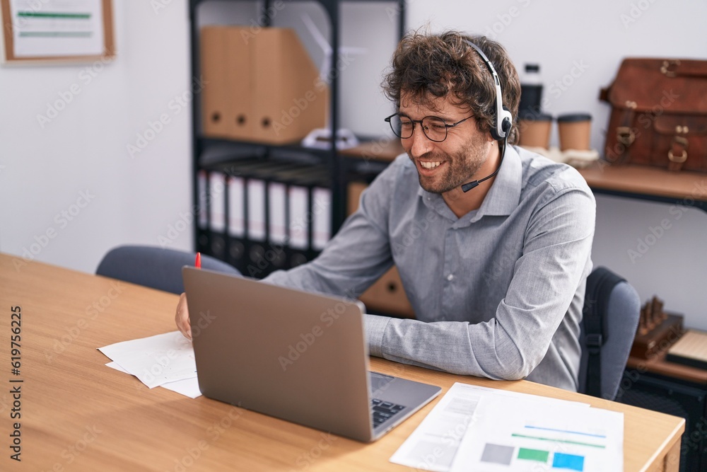 Obraz premium Young hispanic man call center agent smiling confident working at office