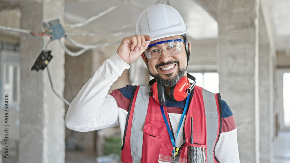 Young latin man builder smiling confident standing at construction site Young latin man builder smiling confident standing at construction site