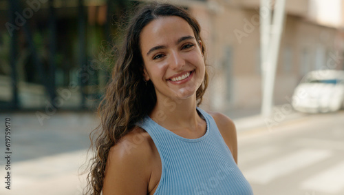 Young beautiful hispanic woman smiling confident standing at street