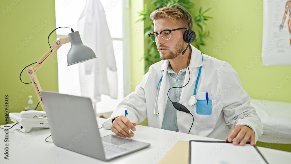 Young caucasian man doctor on video call at clinicc Young caucasian man doctor on video call at clinicc