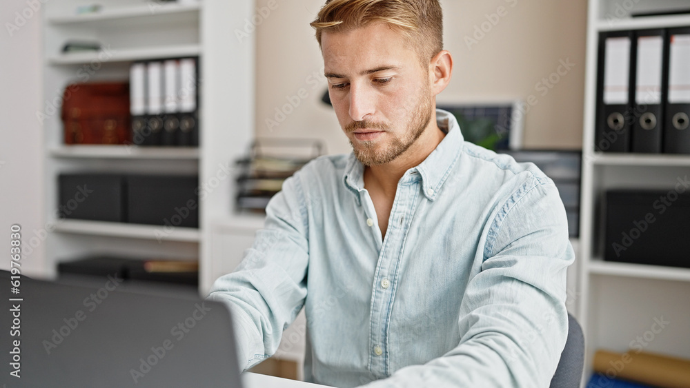 Young caucasian man business worker using laptop working at office