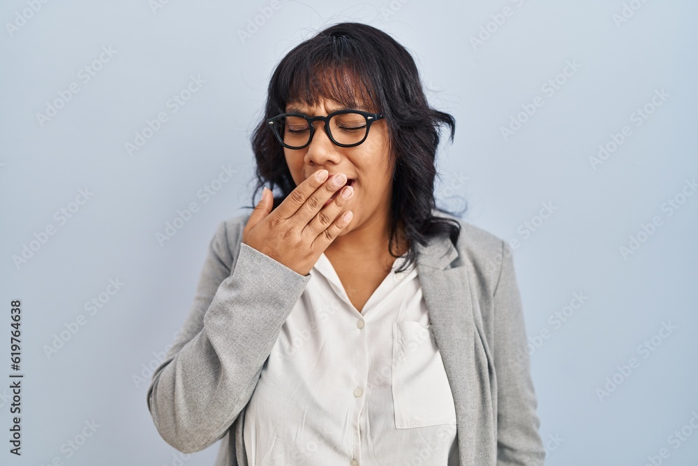 Hispanic woman standing over isolated background bored yawning tired covering mouth with hand. restless and sleepiness. Hispanic woman standing over isolated background bored yawning tired covering mouth with hand. restless and sleepiness.