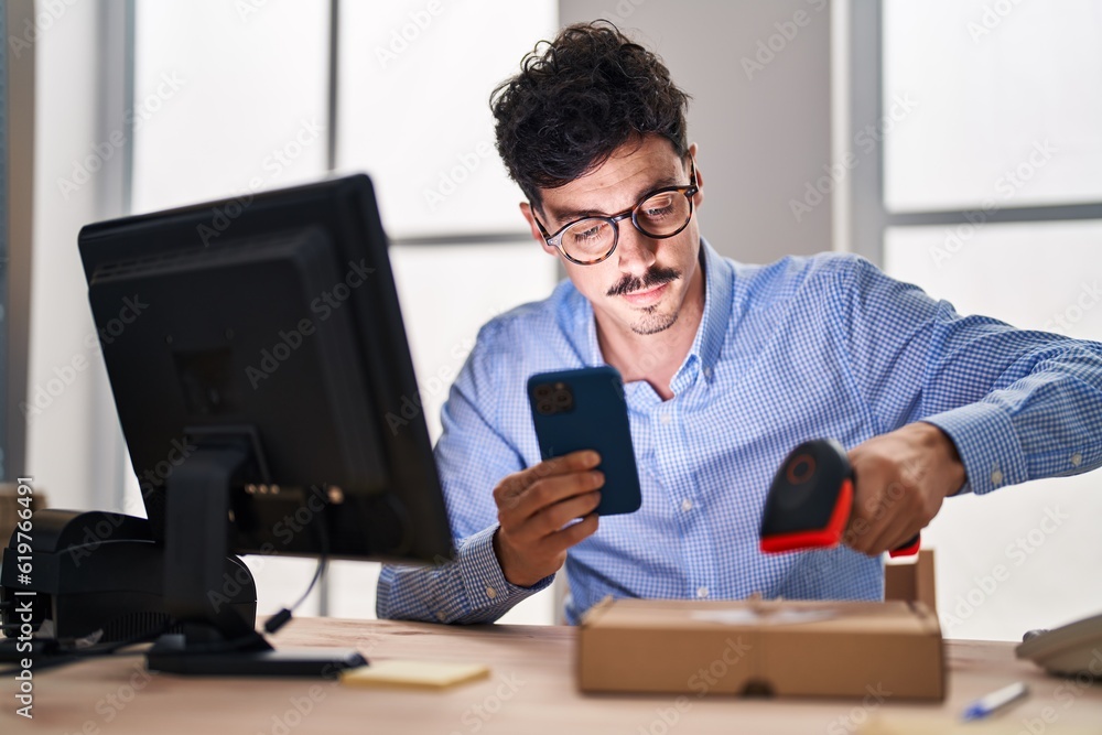 Young caucasian man ecommerce business worker scanning package using smartphone at office