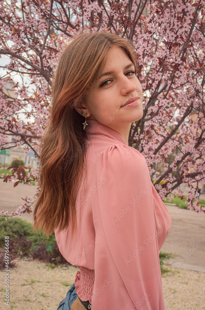 Beautiful portrait of a girl in spring flowers
