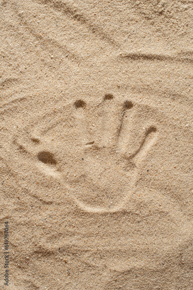 The texture of the sand about the footprints of hands and feet The texture of the sand about the footprints of hands and feet