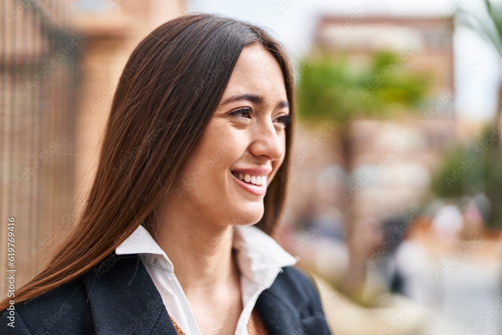 Young beautiful hispanic woman smiling confident looking to the side at street