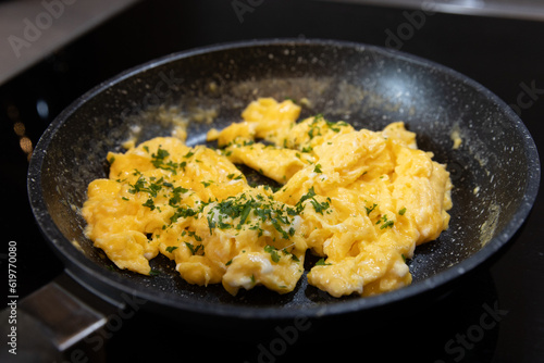 Scrambled eggs in cooking pan. Process of cooking scrambled eggs