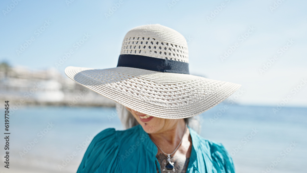 Middle age grey-haired woman tourist smiling confident standing at street