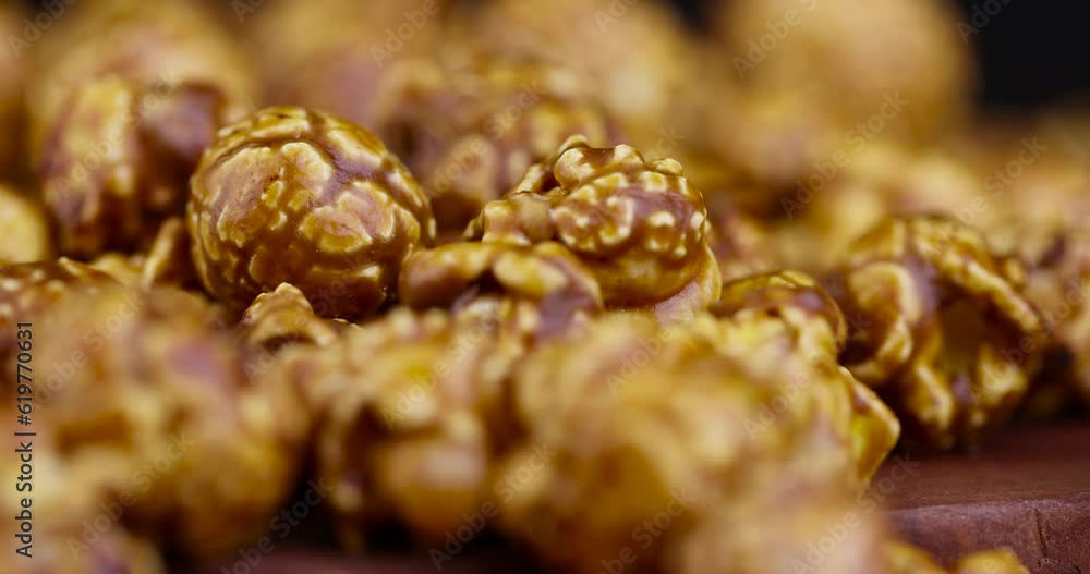 pour delicious sweet popcorn with lots of caramel, caramel flavor of popcorn close-up pour delicious sweet popcorn with lots of caramel, caramel flavor of popcorn close-up