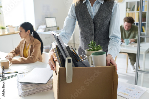 Quadro su tela Close-up of businesswoman packing her things in box and leaving her workplace in