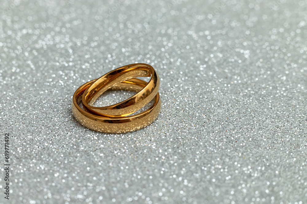 Will you marry me. Two golden wedding rings on silver glitter background. Engagement marriage proposal wedding concept. St. Valentine's Day postcard. Banner on valentines day. Copy space Will you marry me. Two golden wedding rings on silver glitter background. Engagement marriage proposal wedding concept. St. Valentine's Day postcard. Banner on valentines day. Copy space