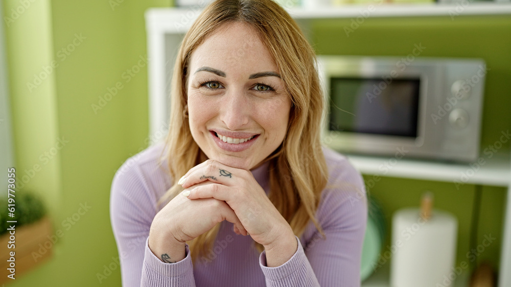 Young beautiful hispanic woman smiling confident with hands on chin at dinning room Young beautiful hispanic woman smiling confident with hands on chin at dinning room