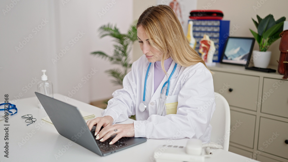 Young beautiful hispanic woman doctor using laptop working at clinic Young beautiful hispanic woman doctor using laptop working at clinic