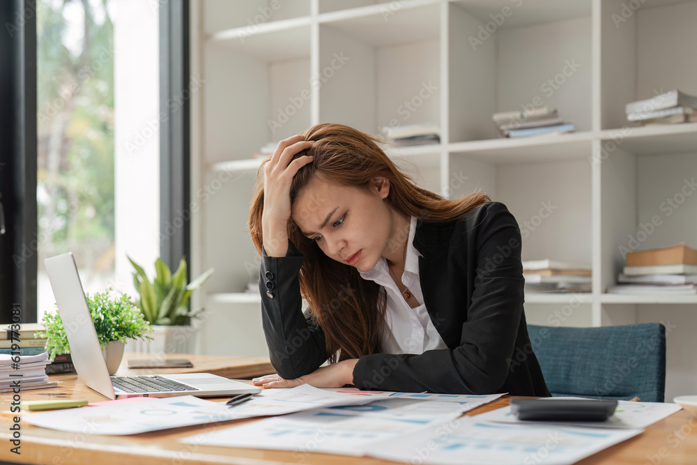 Stress, anxiety and burnout with a business woman at work using a laptop while suffering from a headache Stress, anxiety and burnout with a business woman at work using a laptop while suffering from a headache