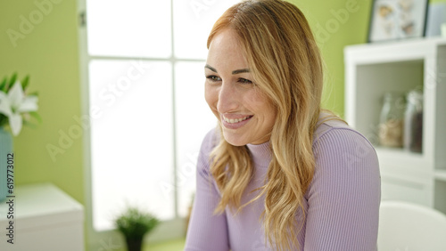 Young beautiful hispanic woman smiling confident at dinning room