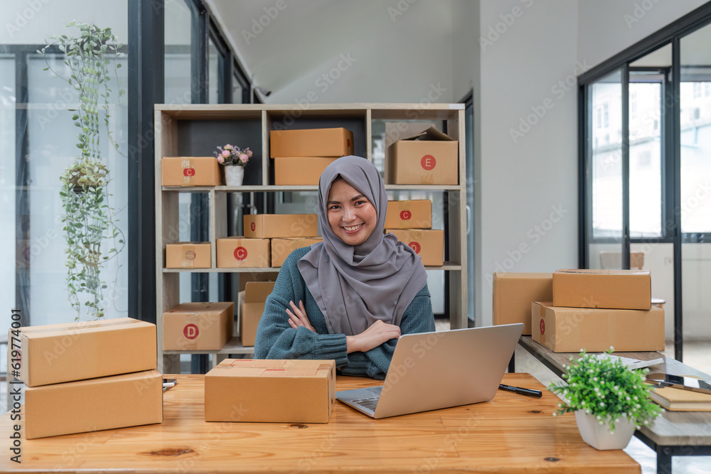 business smiling muslim woman owner preparing product for customer. small online ecommerce shop business smiling muslim woman owner preparing product for customer. small online ecommerce shop
