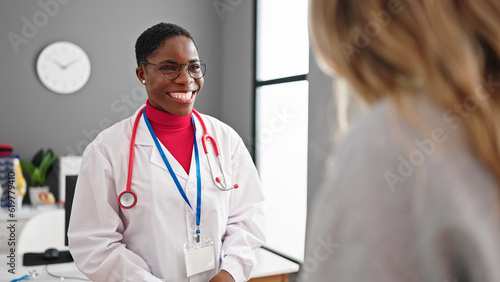 African american woman doctor speaking with patient at clinic