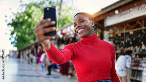African american woman smiling confident making selfie by the smartphone at street market