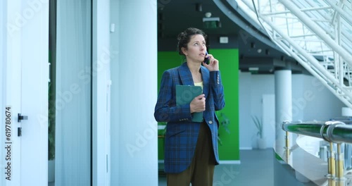 Wallpaper Mural business woman standing in the business centre and talking on the phone with laptop. High quality video footage Torontodigital.ca