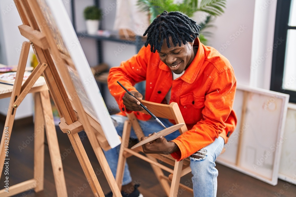 African american man artist smiling confident drawing at art studio