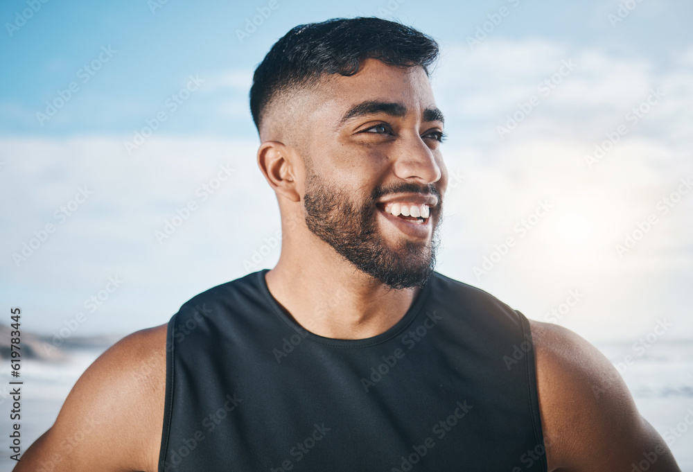 Fototapeta premium Thinking, fitness and face of man on beach ready for exercise, marathon training and cardio workout. Sports, nature and happy Indian male person outdoors for wellness, warm up and running by ocean