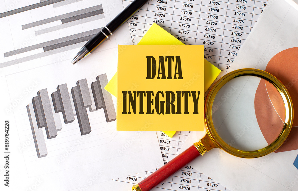 DATA INTEGRITY text on a sticky on the graph background with pen and ...
