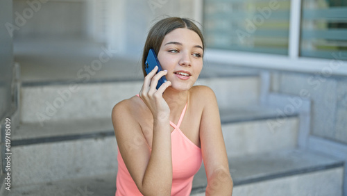 Young beautiful girl smiling confident talking on the smartphone at school