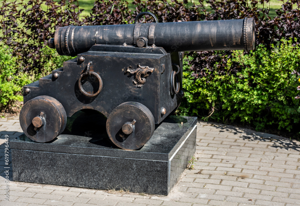 model of an old ship's cannon in the park on a sunny day
