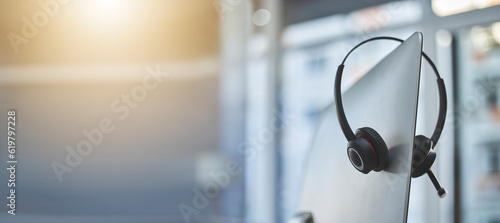 Photos Call center, headset on a computer in an empty office with flare and mockup for communication or assistance