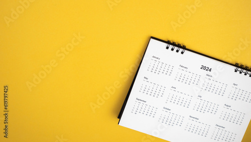 Calendar year 2024 schedule on yellow background.
2024 calendar planning appointment meeting concept. 
copy space.
top view.
 photo
