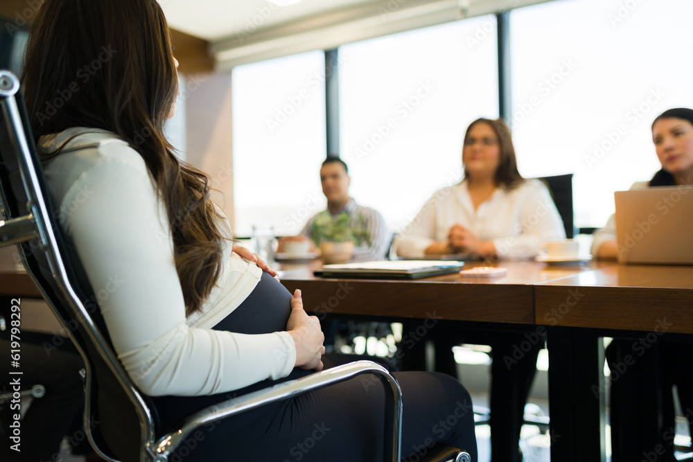 Fototapeta premium Pregnant woman giving job interview at office