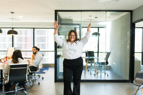 Wallpaper Mural Plus size female professional dancing and celebrating her promotion Torontodigital.ca