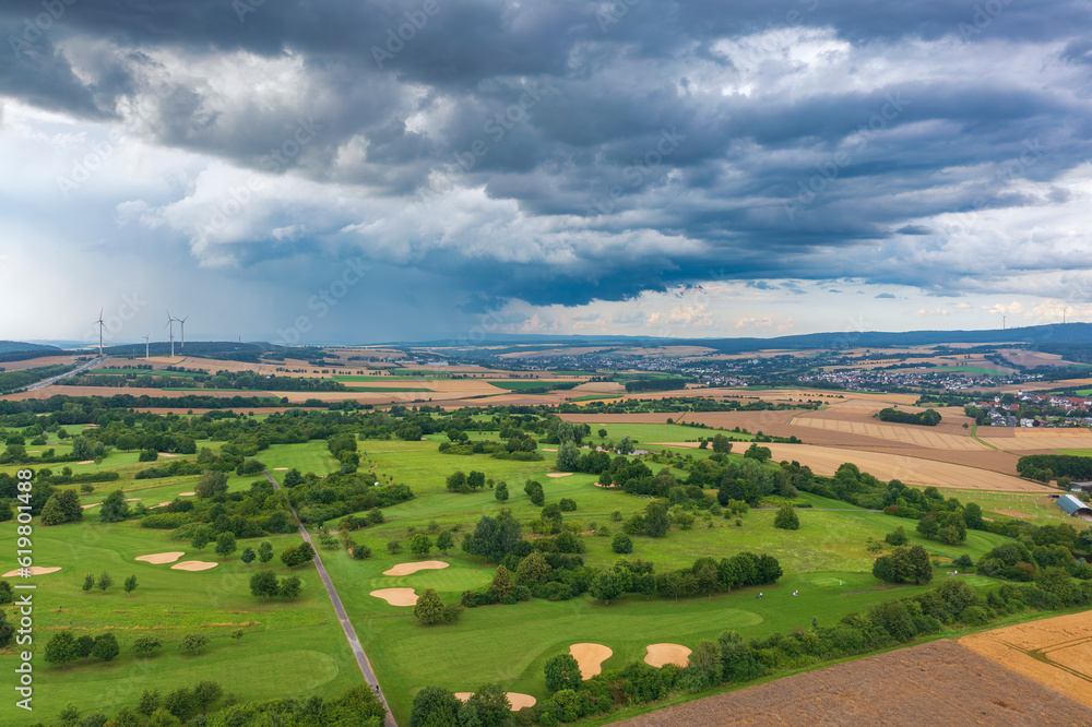 Bird's-eye view of a golf course in Taunus/Germany just before a thunderstorm