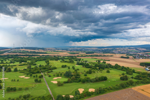 Bird's-eye view of a golf course in Taunus/Germany just before a thunderstorm