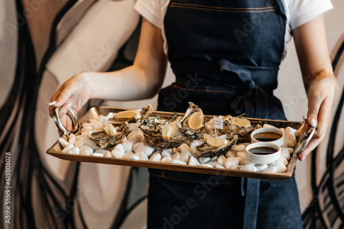 waitress holding tray with oysters in restaurant, Oyster dinner