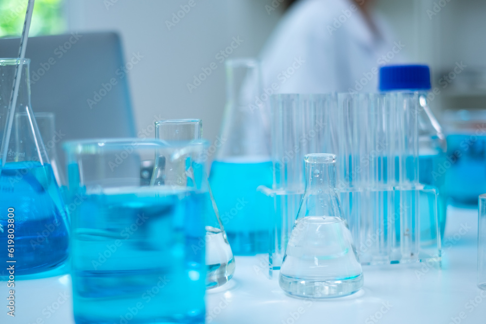 Glassware, beaker or test tube with blue substance or liquid. Concept of laboratory background. Scientific analysis tools background. Chemistry and experiment glassware. Glassware, beaker or test tube with blue substance or liquid. Concept of laboratory background. Scientific analysis tools background. Chemistry and experiment glassware.