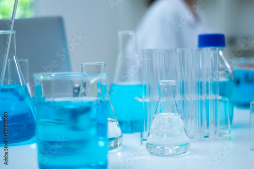 Glassware, beaker or test tube with blue substance or liquid. Concept of laboratory background. Scientific analysis tools background. Chemistry and experiment glassware.