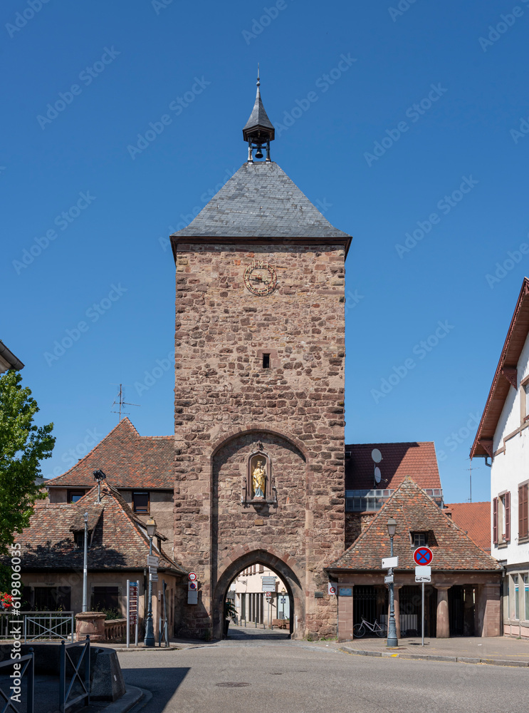 Molsheim, France - 06 24 2023: City of Molsheim. View of the entrance door on the Blacksmiths Gate with a statue of Mary.