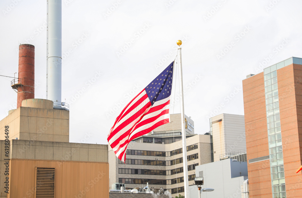 US flag waves proudly on July 4th, symbolizing patriotism and honoring fallen heroes. Amidst economic challenges, it represents resilience and unity