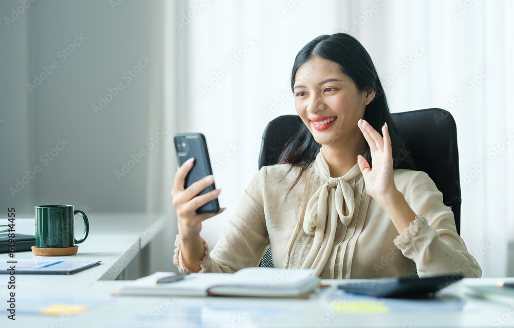 Smiling young woman having video call on mobile phone and enjoying pleasant conversation. Smiling young woman having video call on mobile phone and enjoying pleasant conversation.